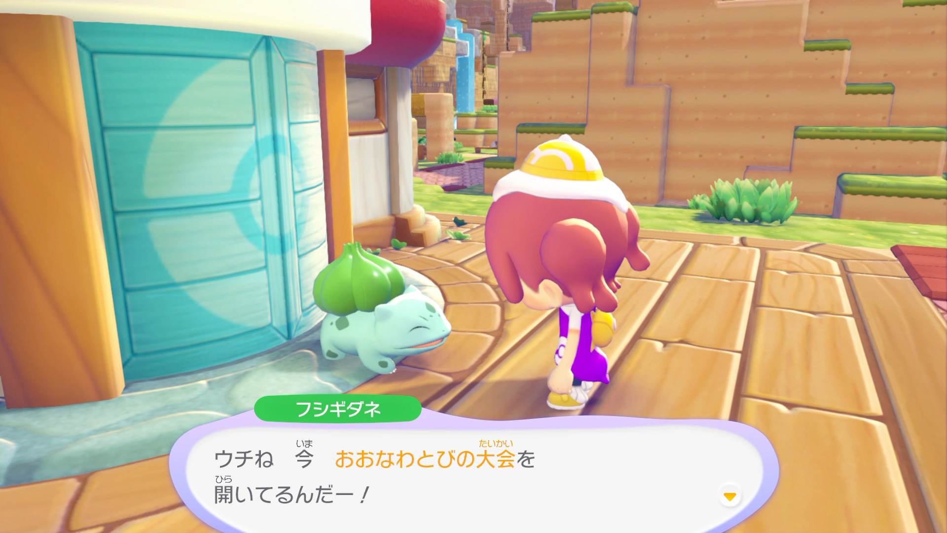 Bulbasaur habla con el personaje del jugador junto al Centro Pokémon